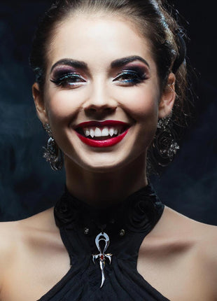 Susannah is wearing the first Generation Legacy Ankh in Rhodium Protected Sterling Silver with Faceted Red Garnet. She is wearing Lilith Laterals  3D Printed Fangs. Makeup by Johanna Moresco.